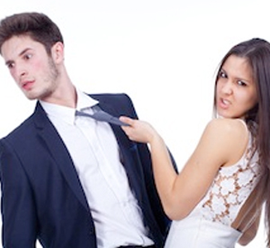 Girl pulling man’s tie